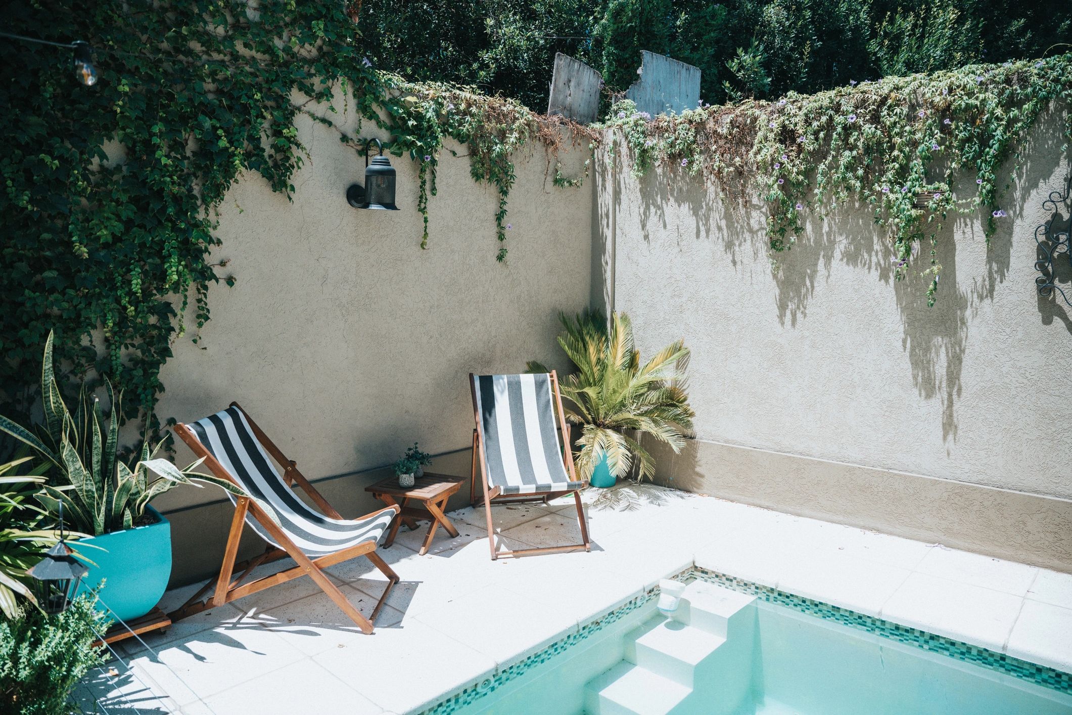 Sun loungers beside a private pool patio