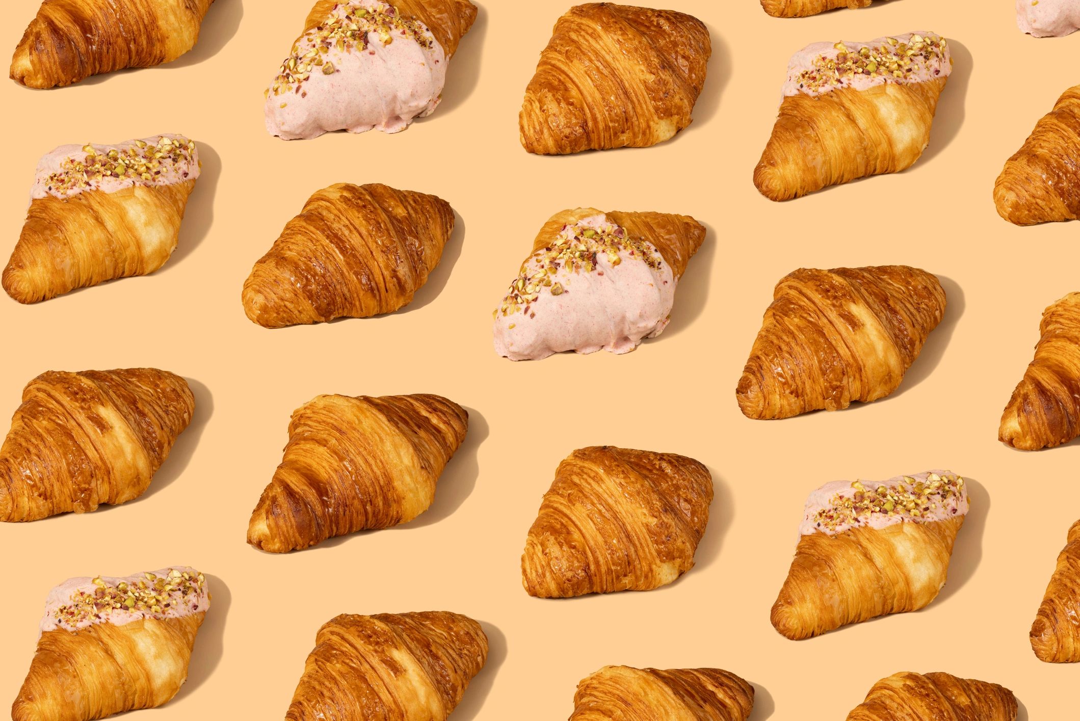 Fresh croissants on a pastel background
